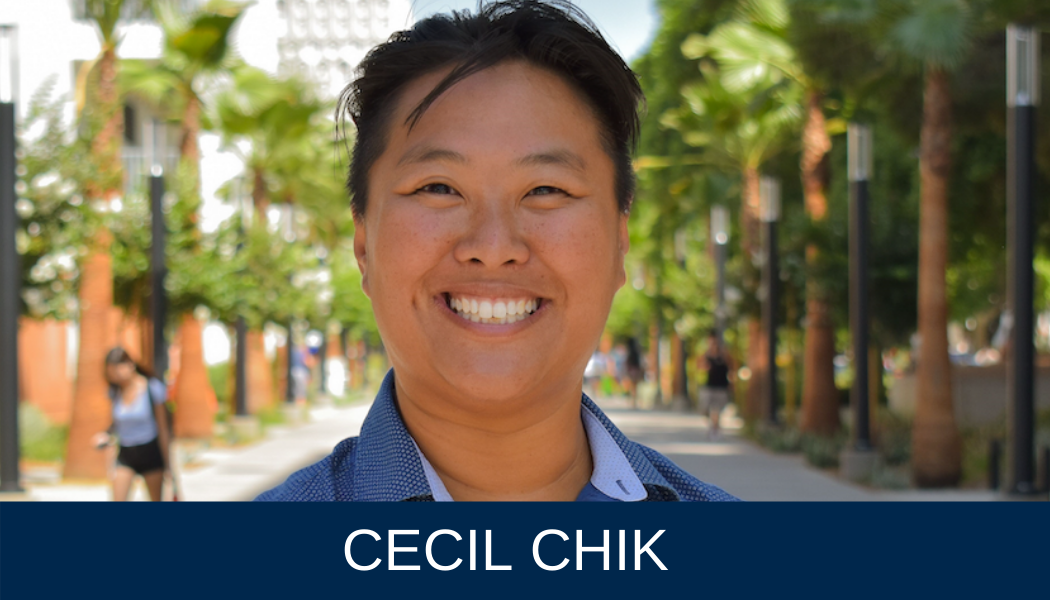 Employee Cecil Chik standing in front of palm trees at CSUF