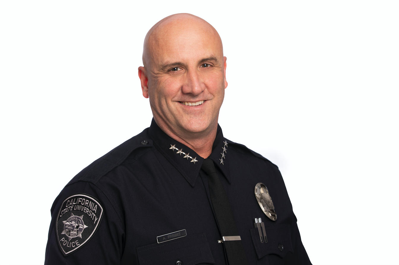 Chief of Police Anthony Frisbee in dark blue police uniform and white background